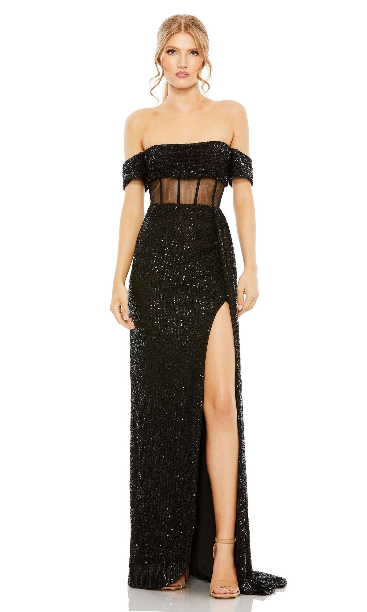 A woman wears the Long Formal Dress 11665 by Mac Duggal, featuring an off-the-shoulder sequin design with a sheer corset bodice and high slit, paired with nude high-heeled sandals for a glamorous formal look.